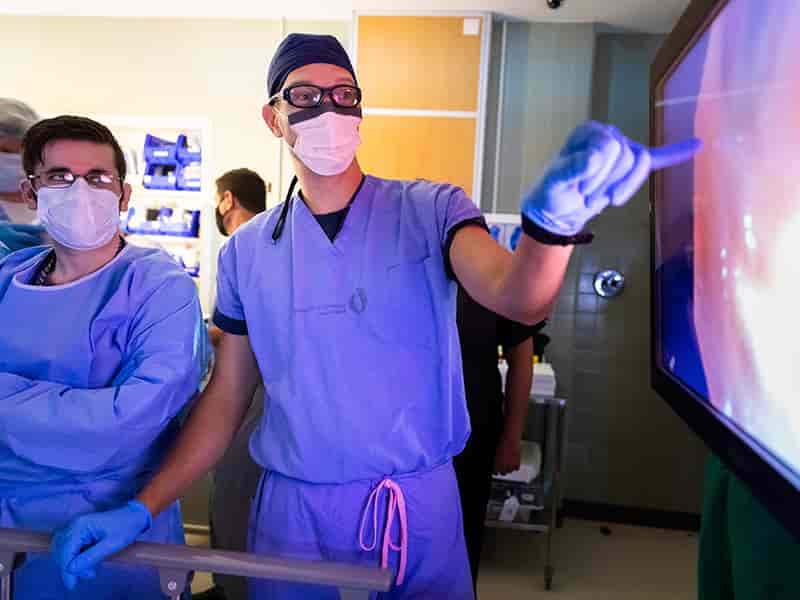 Dr. Michal Senitko, right, goes over video of a lung volume reduction with resident Dr. Clifford Coile.